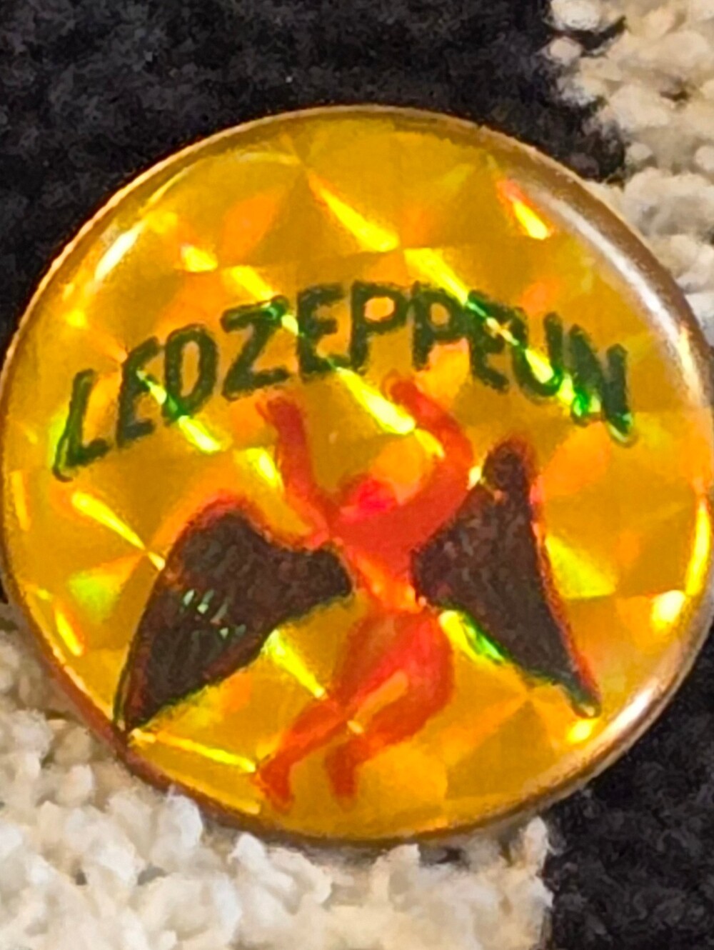 vintage Led Zeppelin angel pin featuring a reflective yellow prism background